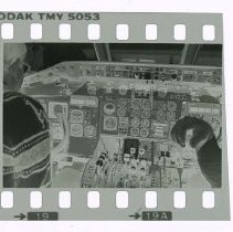 Filmstrip of Two unidentified men zoomed in an airplane cockpit
