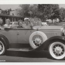 Black and white photo of a group of four in a Ford Model A