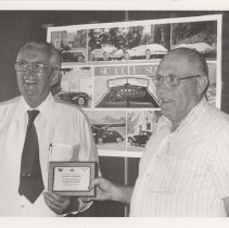 Black and white photo of Lloyd H. Davidson receiving an award for 50 years of Engineering and Product Development