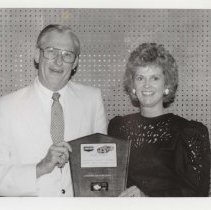 Black and white photo of Richard and Linda Kughn holding an ACD Club awards plaque