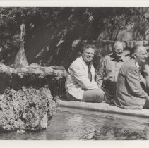 Black and white photo "Bob Robinson, Sam Oliphant, Harry Henkel, and John Martin Smith stop for a drink of water while on tour"