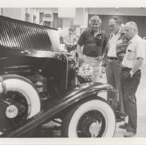 Black and white photo "Harry Henkel, right, shows his 1931 Auburn Brougham to Ken Rogers and Stan Gilliland"