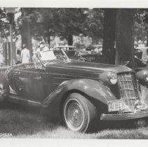 1986 black and white photo of a replica Auburn 851 speedster in a grassy park