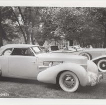 1986 black and white photo of Cord 810-812 phaeton in a grassy park