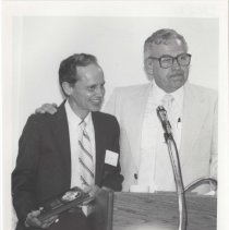 Black and white photo of two ACD Club members at a podium