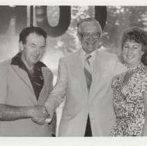 Black and white photo of a group of three unidentified people at the awards ceremony
