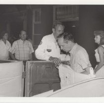 Black and white photo of Chuck Marsh in a labelled shirt