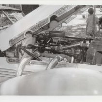 Black and white photo looking in the hood of a 1937 Cord 812