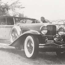 Man standing next to a 1930 Duesenberg Model J-453