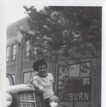 Man in a cowboy hat next to a 1936 Auburn 654 in front of the museum