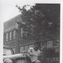 Man next to a 1936 Auburn 654 in front of the museum