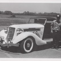 Man stepping out of a 1935 Auburn 851 cabriolet