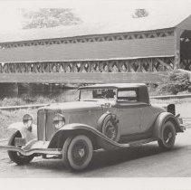 1931 Auburn cabriolet next to a covered bridge