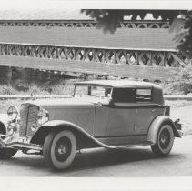 1931 Auburn phaeton next to a covered bridge