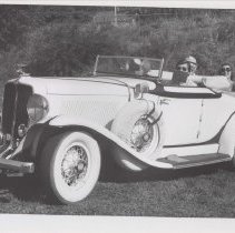 Four people in a 1931 Auburn roadster