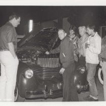 Group of men in front of the open hood of a Cord 810-812