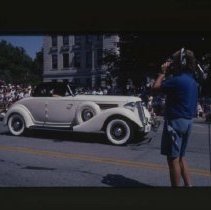 1935 - 1936 Auburn Cabriolet driving down Main Street