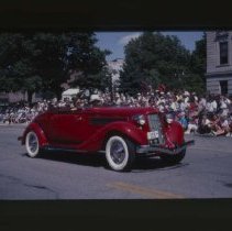 1935 - 1936 Auburn Cabriolet driving down Main Street