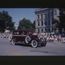 1928 - 1930 Auburn Sedan driving down Main Street