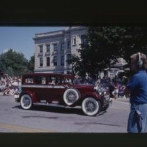 1928 - 1930 Auburn Sedan driving down Main Street