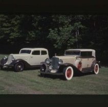 1931 Auburn Phaeton and a 1934 Auburn Brougham on grass