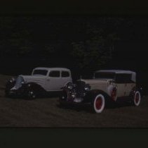 1931 Auburn Phaeton and a 1934 Auburn Brougham on grass