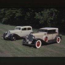 1931 Auburn Phaeton and a 1934 Auburn Brougham on grass