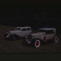1931 Auburn Phaeton and a 1934 Auburn Brougham on grass
