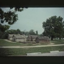 Log cabin on side of road
