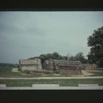 Log cabins on side of road