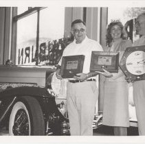 Three people holding ACD Club awards in the museum