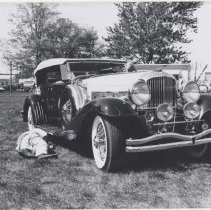 Man checking under a Duesenberg Model J-537 in a park