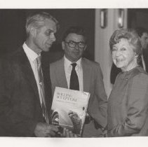 Three people with the Rolling Sculpture book