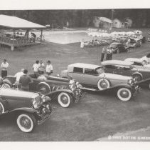 Lineup of Duesenbergs in a park