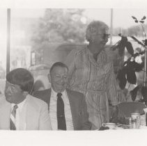 A woman and two men in the museum showroom