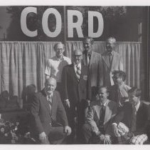 Eight men outside the museum