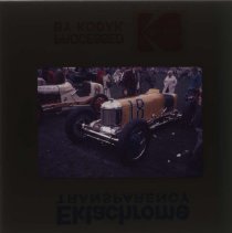 A boy looking at a Miller racecar