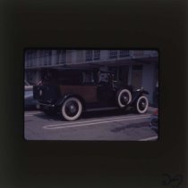 Black Rolls-Royce with patterned back doors and rear
