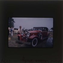 Man looking at a Rolls-Royce with a phaeton body style