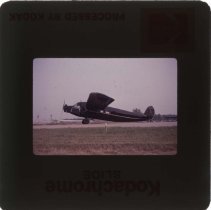 Black Stinson aircraft on a runway