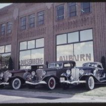 Two 1933 Auburns and a 1931 Auburn Speedster in front of the museum