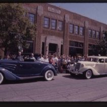 1934 Auburn Cabriolet and 1935 or 1936 Auburn Sedan in front of the museum