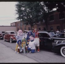 Clowns in front of a Cord 810-812 Sedan and other ACD cars