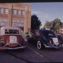 1934 Auburn and Cord 810-812 Sedan in the parking lot of the museum