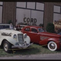 1935 or 1936 Auburn Cabriolet and Cord 810-812 Sedan in front of the museum