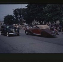 1931 Auburn and a Duesenberg Model J Convertible Coupe in front of the Auburn Courthouse