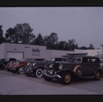 1933 Auburn Sedan, 1935 or 1936 Auburn Phaeton, 1934 Auburn in front of Ester Price Candies