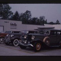 1933 Auburn Sedan, 1935 or 1936 Auburn Phaeton, 1934 Auburn in front of Ester Price Candies