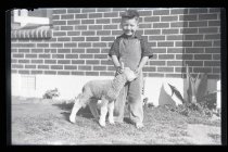Young boy with pet lamb
