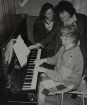 Trudy Foster, Helen Maynall and Lorraine Young around a piano